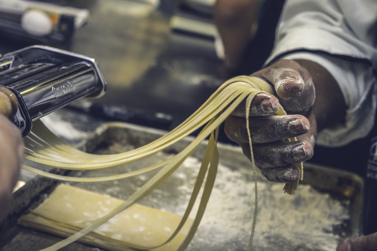 Hand-rolled tagliatelle drying on rods