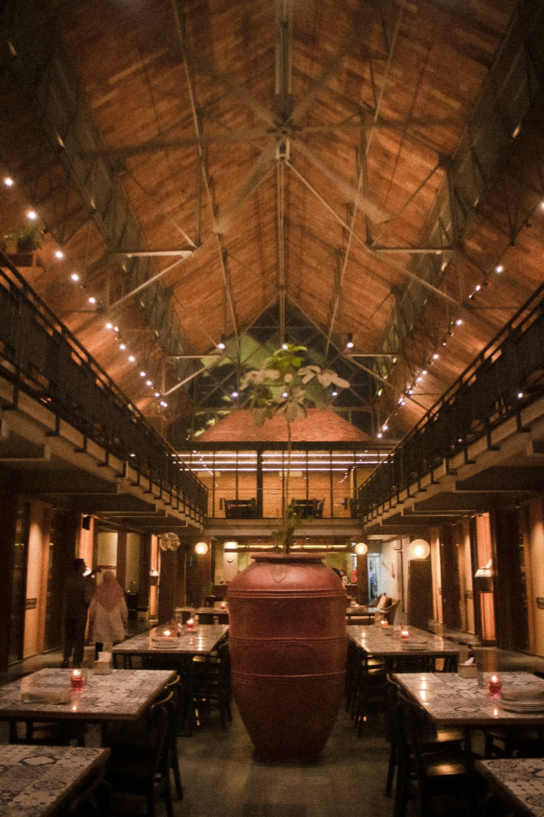 The soaring, daylit dining room of République under its arched clerestory windows