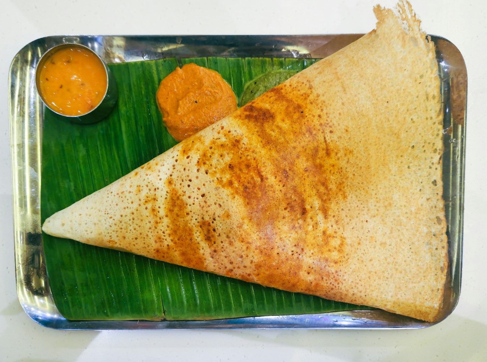 The intimate dining room at Semma, dosa griddle glowing at the pass