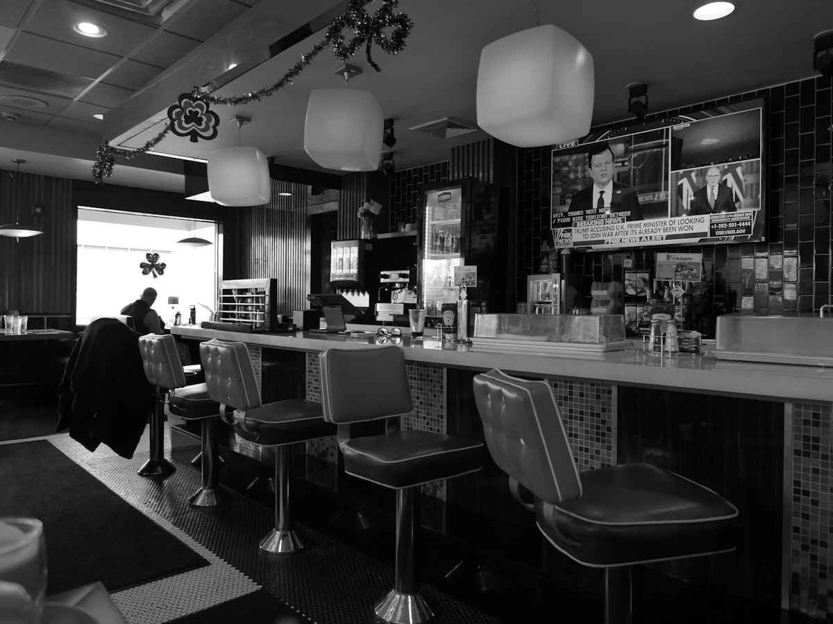 Regulars at the counter, coffee already poured